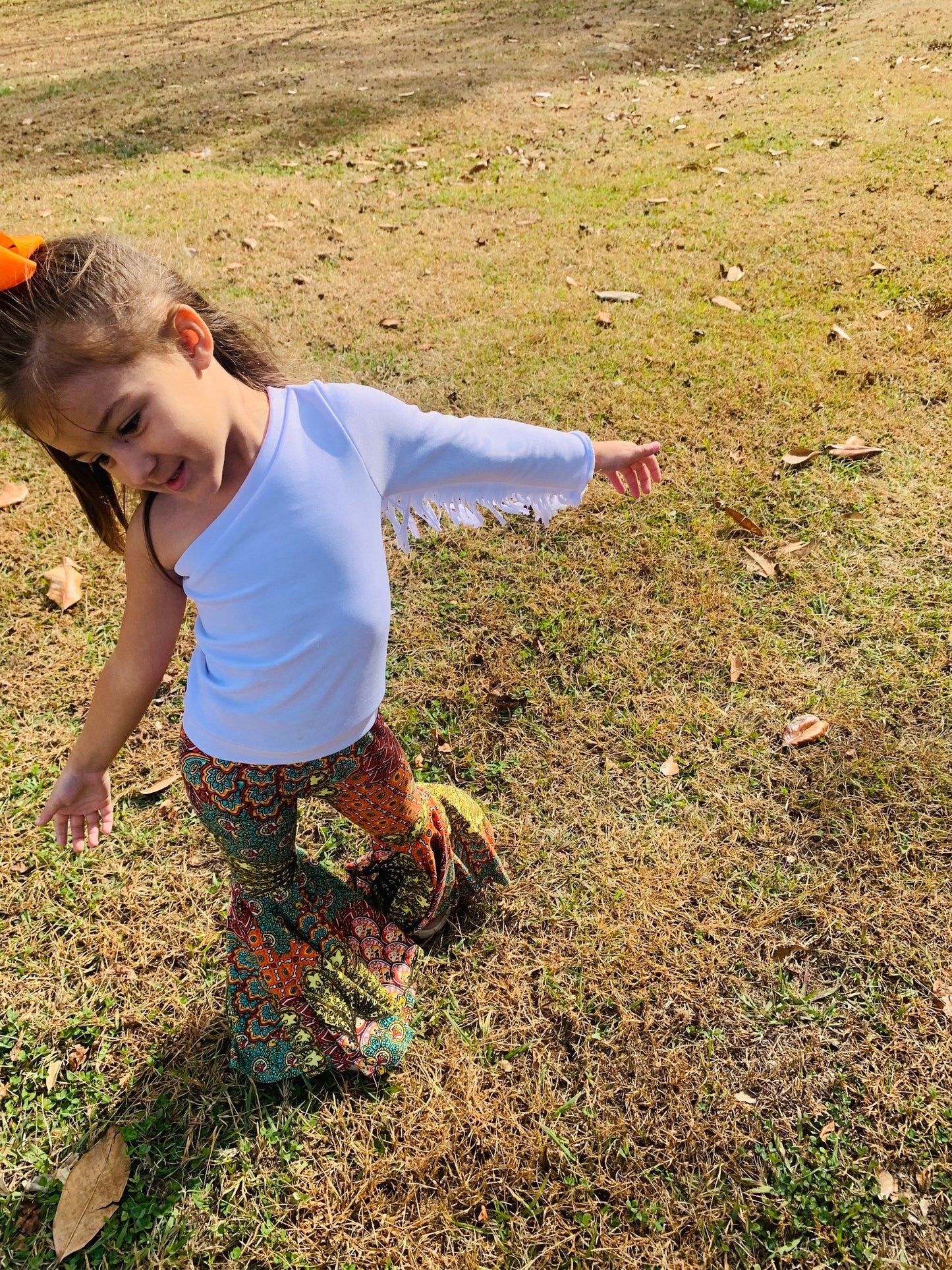 Retro Vibes: Bell Bottom Pants & One Shoulder Fringe Top for Kids - Trendy and Comfortable Outfit for Dancing and Playtime! WHOLESOME GOODS